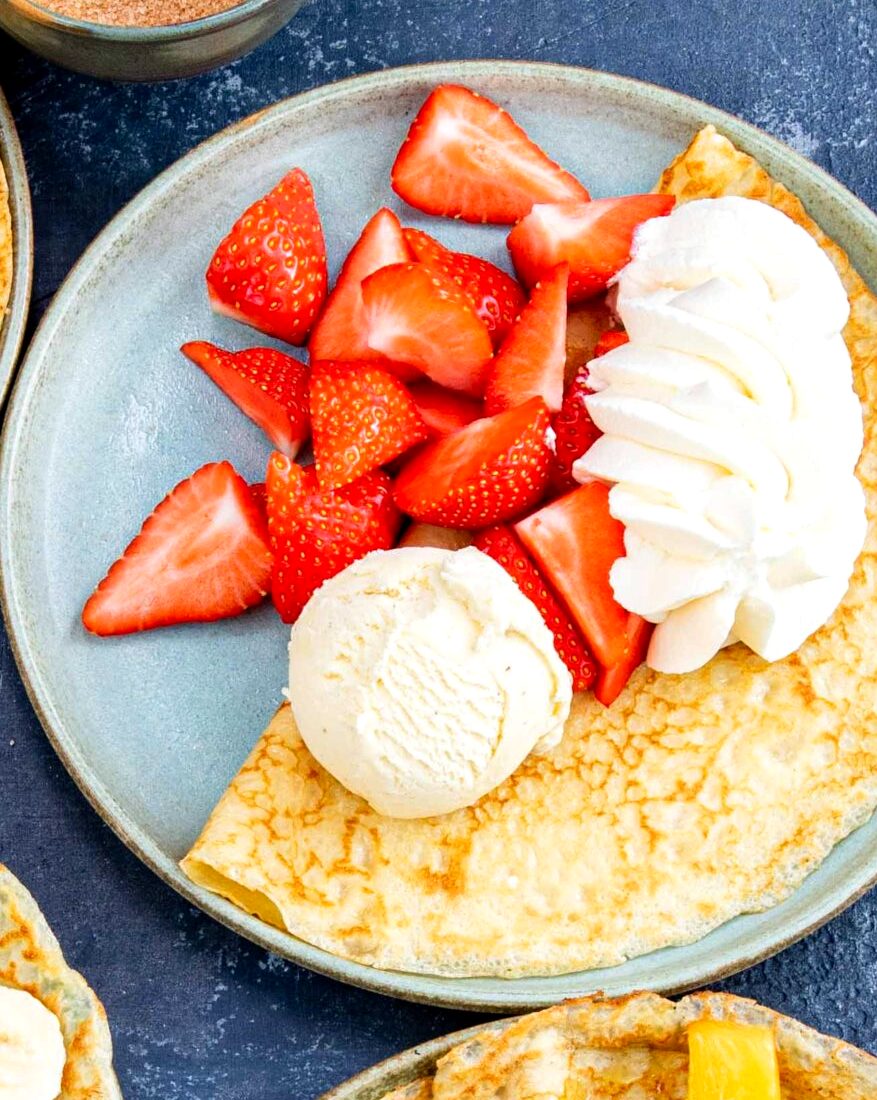 Dutch pancake with strawberries and whipped cream
