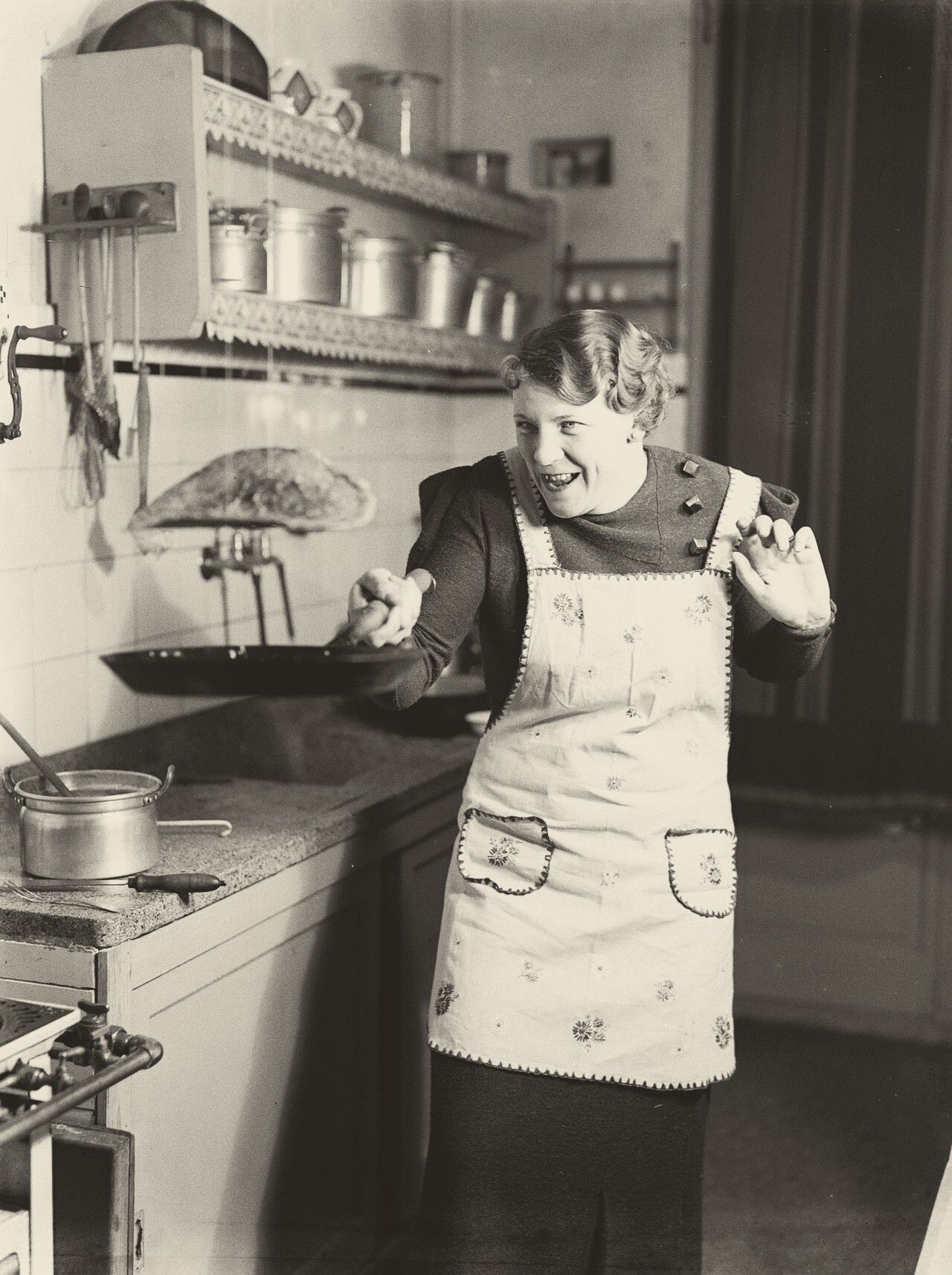 Nell Langlais flips a pancake by tossing it in the air